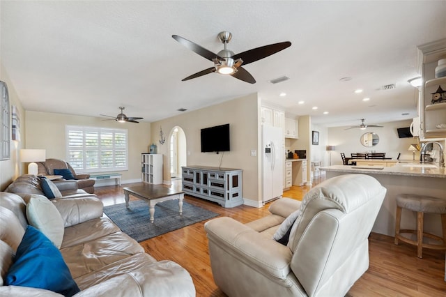 living room featuring light hardwood / wood-style floors and sink