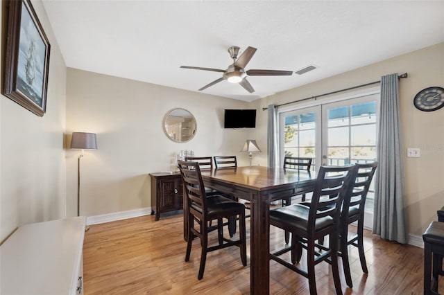 dining room with light wood-type flooring and ceiling fan