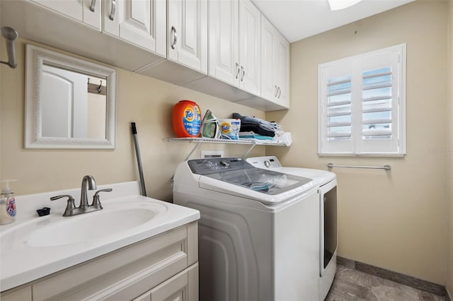 laundry room featuring sink, cabinets, and washing machine and dryer