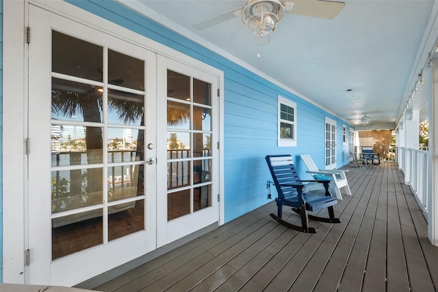 deck featuring ceiling fan, french doors, and covered porch