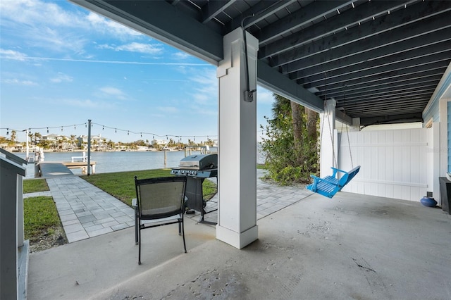 view of patio / terrace with area for grilling and a water view