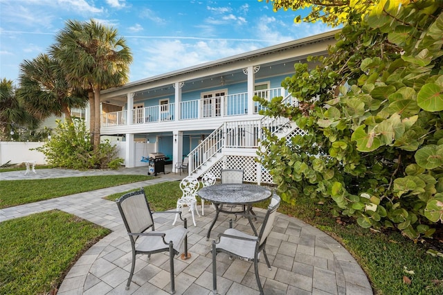 back of house featuring a porch and a patio