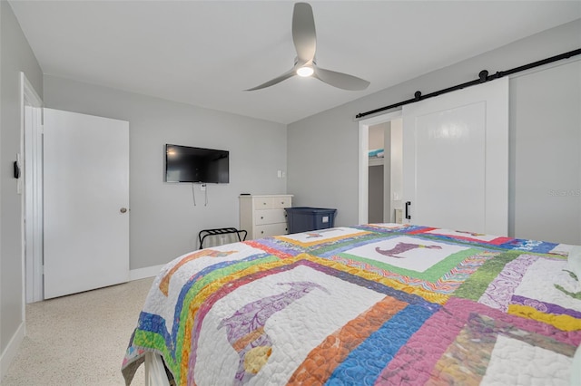 bedroom with a barn door and ceiling fan