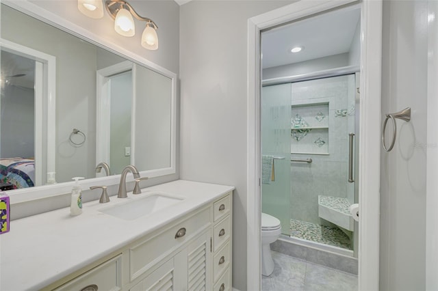 bathroom with vanity, toilet, and an enclosed shower