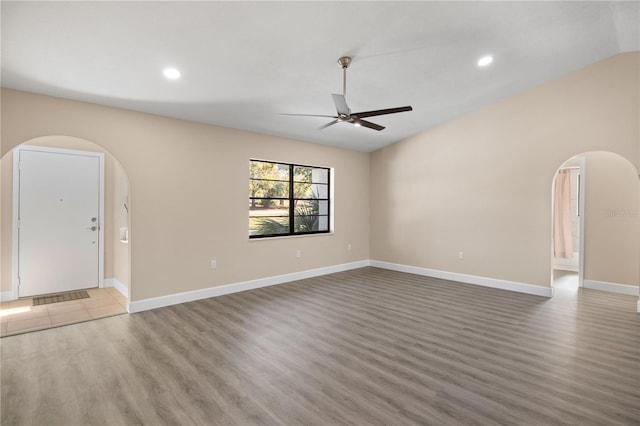 unfurnished living room with ceiling fan and light wood-type flooring