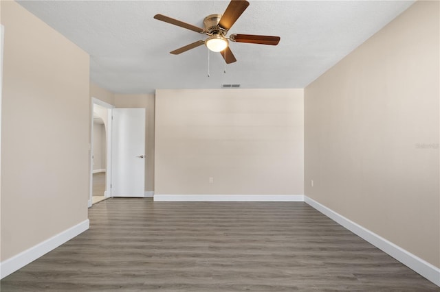 unfurnished room featuring a textured ceiling, ceiling fan, and dark hardwood / wood-style floors