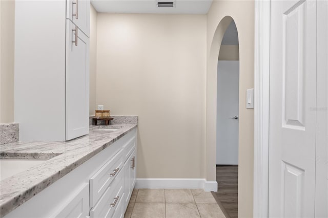 bathroom with tile patterned flooring and vanity