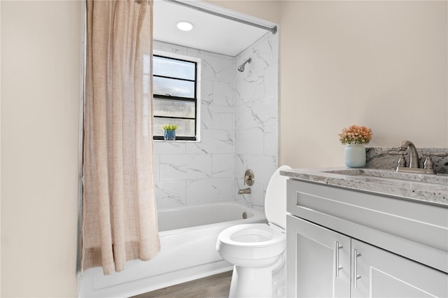 full bathroom featuring toilet, vanity, hardwood / wood-style flooring, and shower / bath combo with shower curtain