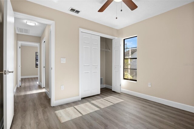 unfurnished bedroom featuring a closet, ceiling fan, and light hardwood / wood-style floors