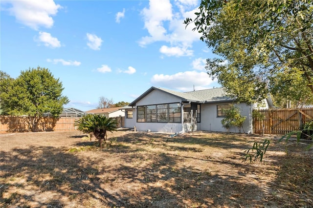 back of house featuring a yard