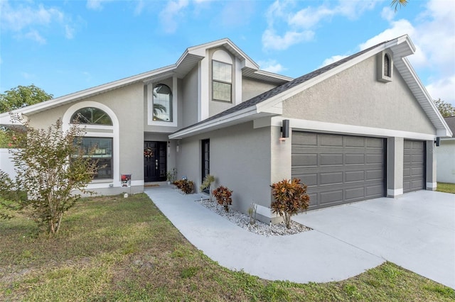 view of front of property with a front yard and a garage