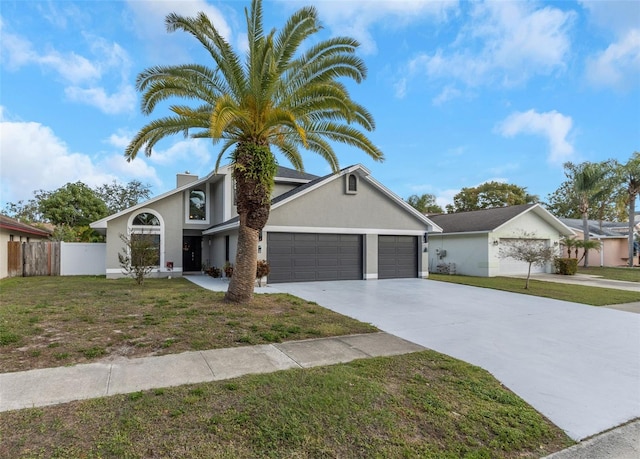 view of front facade with a garage and a front lawn