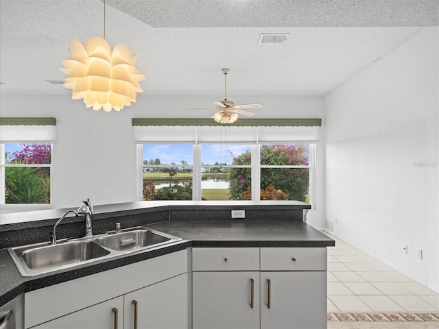 kitchen with sink, white cabinetry, and a wealth of natural light