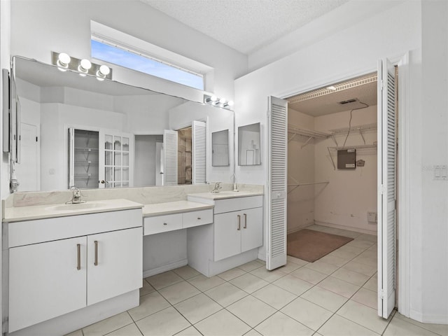 bathroom with vanity and a textured ceiling