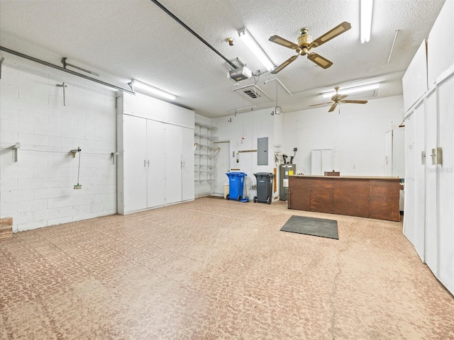 garage with electric panel, ceiling fan, water heater, and a garage door opener