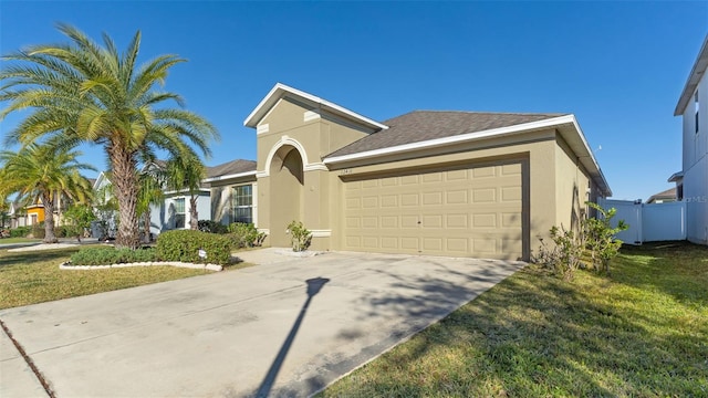 single story home with a garage and a front lawn