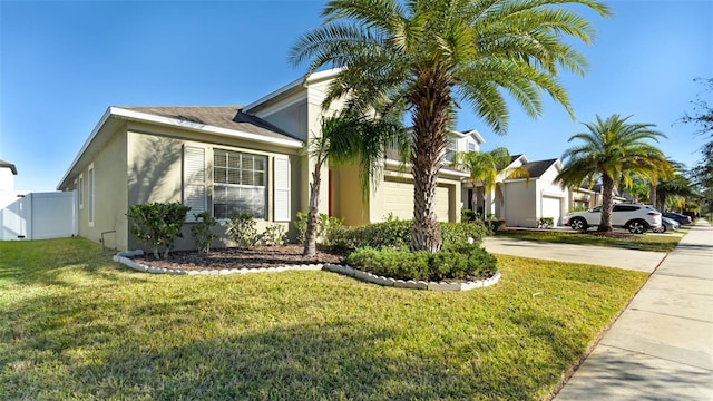 view of front of home featuring a front yard and a garage