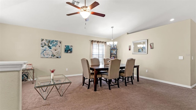 dining space featuring ceiling fan with notable chandelier, carpet floors, and vaulted ceiling