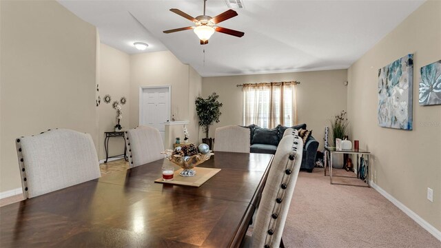 carpeted dining room featuring ceiling fan