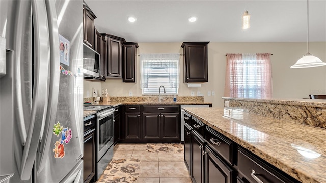 kitchen with pendant lighting, sink, light tile patterned floors, appliances with stainless steel finishes, and dark brown cabinetry