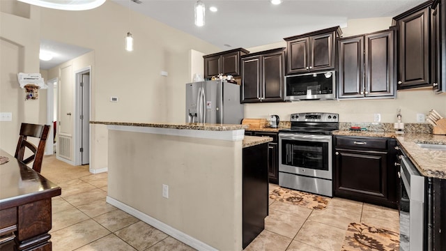 kitchen with light stone countertops, a center island, stainless steel appliances, and light tile patterned flooring