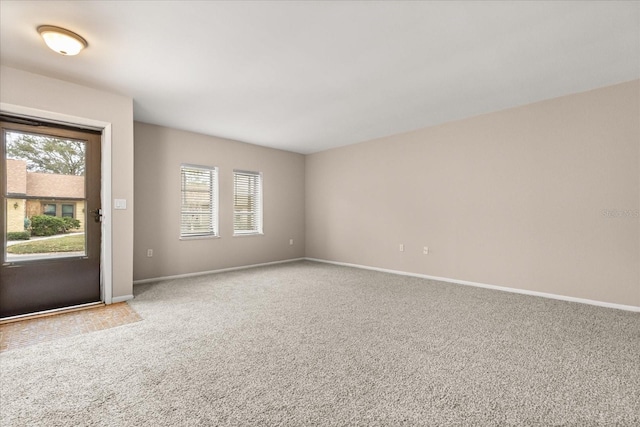 carpeted empty room featuring plenty of natural light