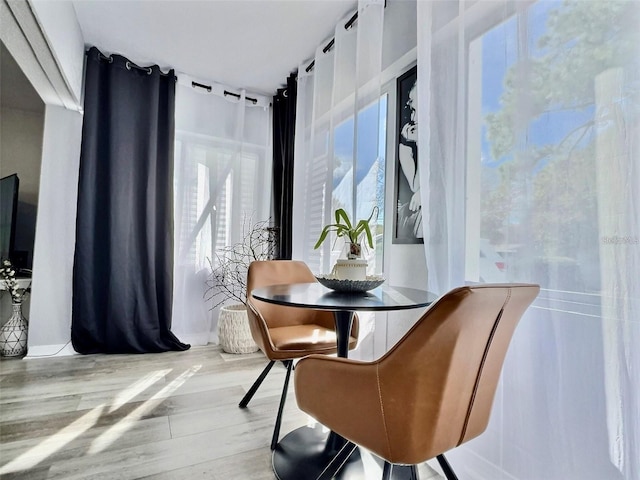 dining room featuring plenty of natural light and light hardwood / wood-style flooring