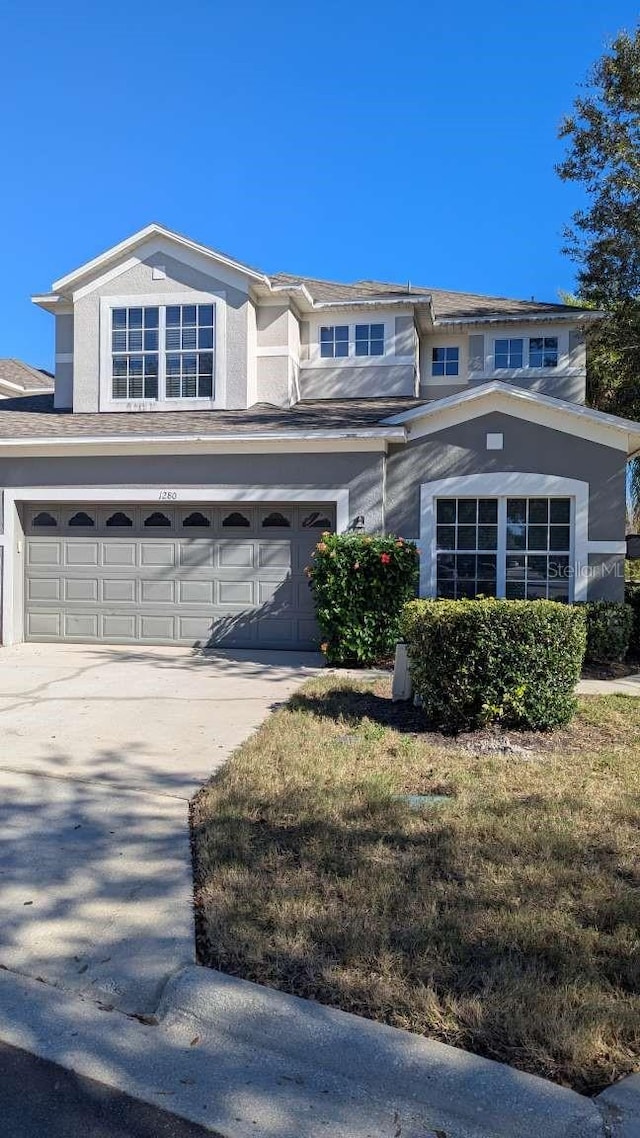 view of front of property featuring a garage and a front lawn