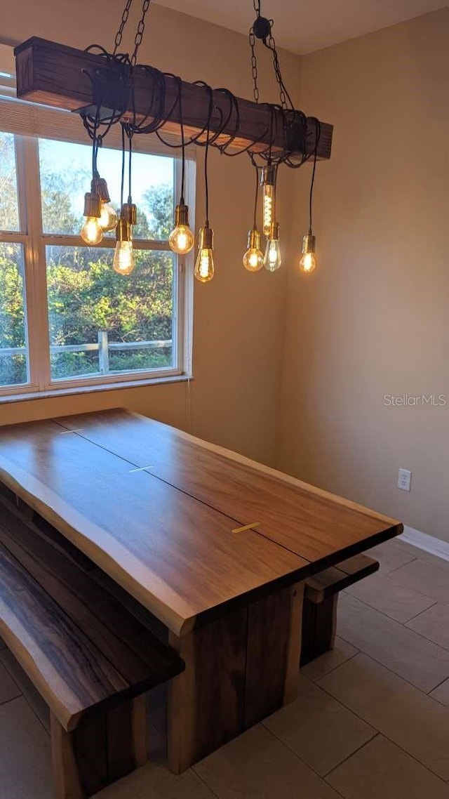 unfurnished dining area featuring tile patterned floors