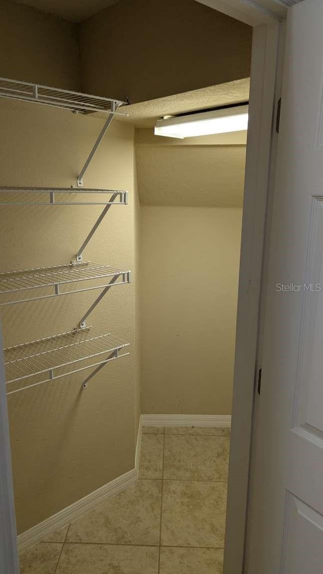 spacious closet with tile patterned flooring