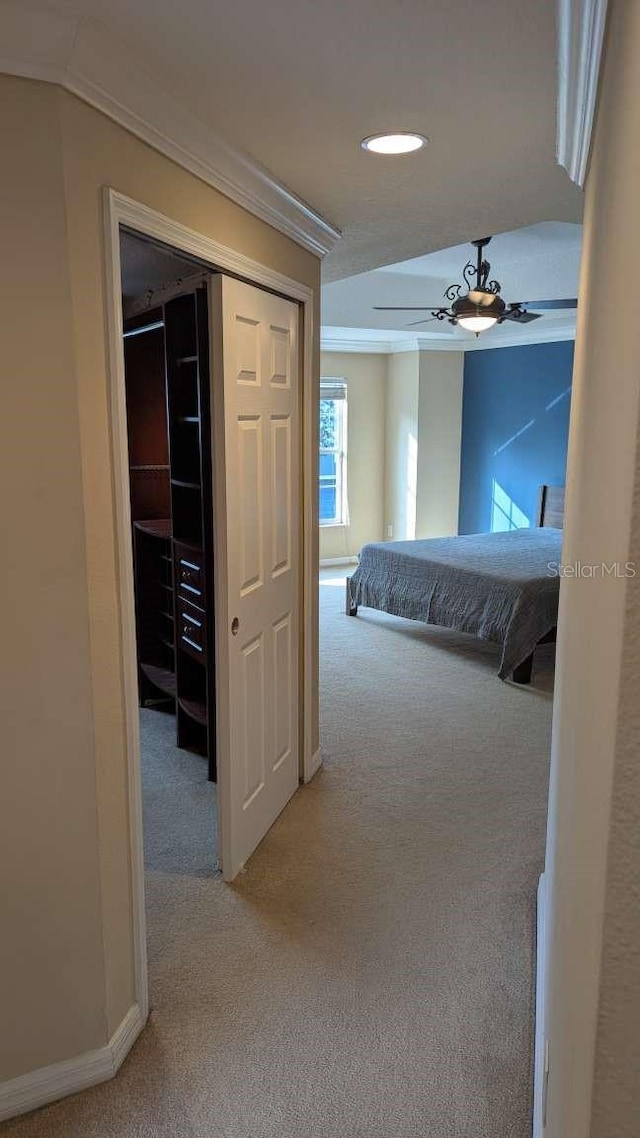 hall with carpet and ornamental molding