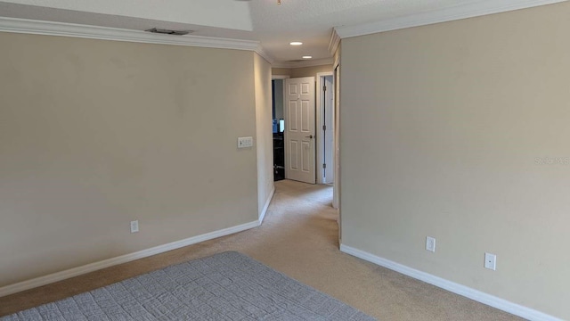 hallway with light carpet, a textured ceiling, and crown molding