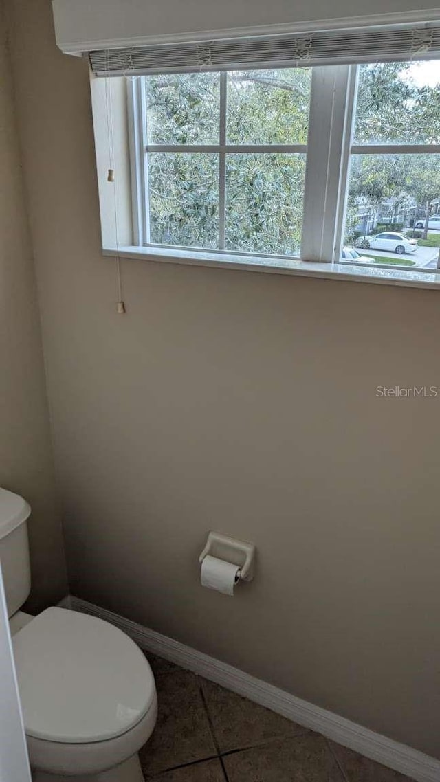 bathroom with tile patterned floors and toilet