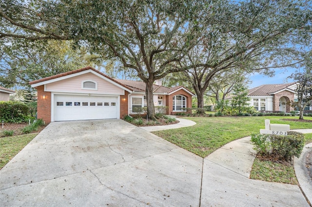 ranch-style house featuring a garage and a front lawn