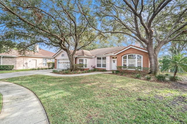 ranch-style house featuring a garage and a front yard