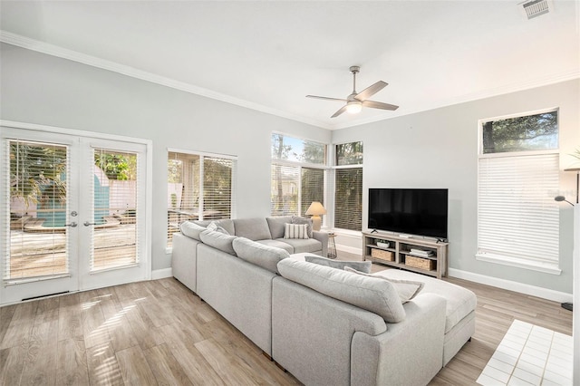 living room with ceiling fan, french doors, crown molding, and light hardwood / wood-style flooring