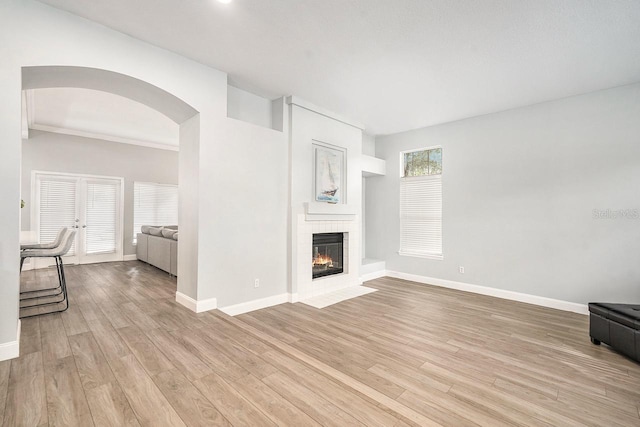 unfurnished living room with a large fireplace and light hardwood / wood-style floors