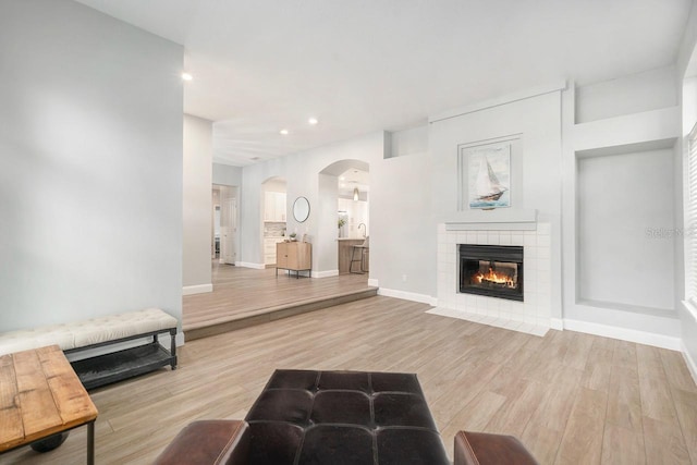 living room with light hardwood / wood-style flooring and a fireplace