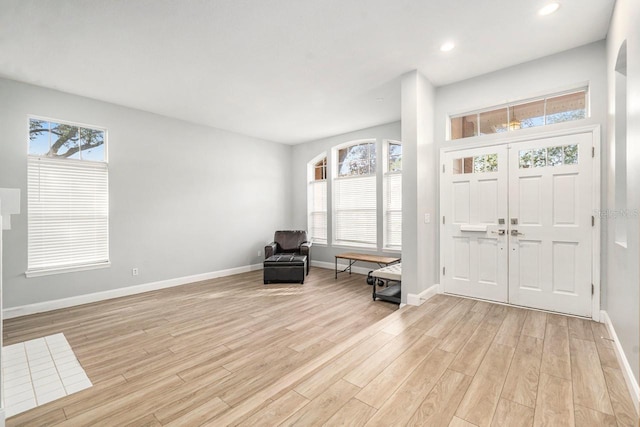 foyer featuring light wood-type flooring and plenty of natural light