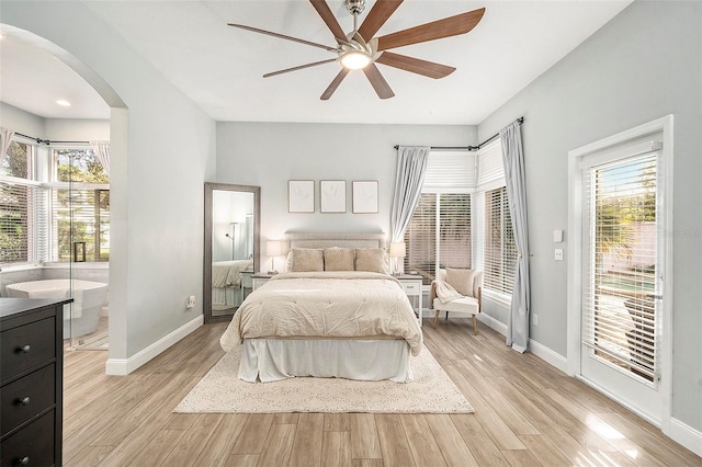 bedroom with ceiling fan, access to exterior, multiple windows, and light hardwood / wood-style floors