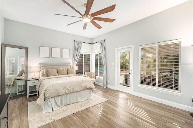 bedroom featuring ceiling fan, light hardwood / wood-style floors, and access to outside