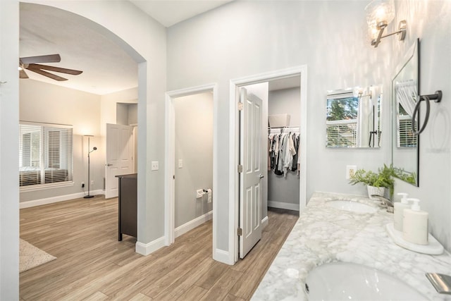 bathroom with ceiling fan, wood-type flooring, and vanity