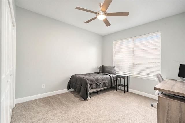 carpeted bedroom featuring ceiling fan and multiple windows