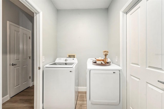 laundry room featuring washer and dryer and hardwood / wood-style floors