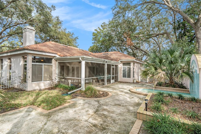 back of property featuring a patio and a sunroom