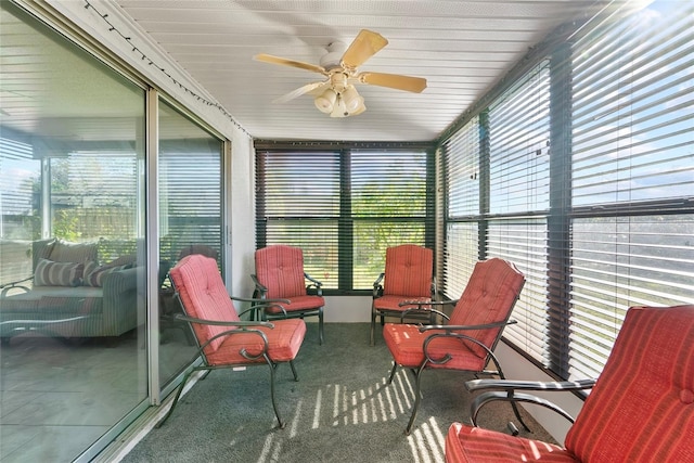 sunroom / solarium featuring ceiling fan