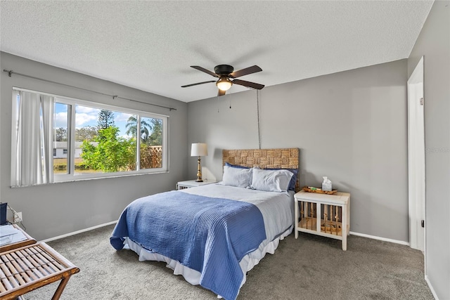 carpeted bedroom with ceiling fan and a textured ceiling