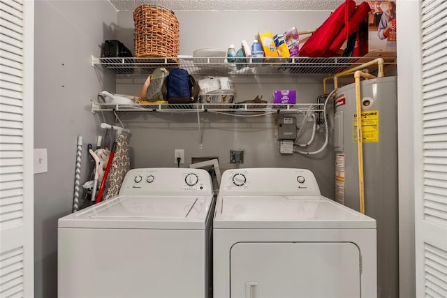 washroom featuring water heater and washer and dryer