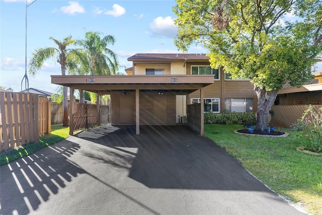 view of front facade featuring a carport and a front lawn