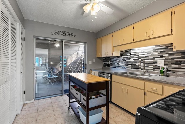 kitchen with black electric range oven, sink, light tile patterned floors, stainless steel dishwasher, and ceiling fan